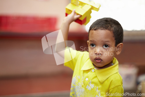 Image of Boy, education and building blocks in classroom for development, scholarship and thinking at kindergarten. Happy student child, plastic toys and playing with idea for learning, academy or preschool