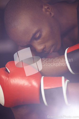 Image of Fitness, thinking or sad boxer after loss, failure or defeat in combat or sports battle in a boxing ring. Black man, loser or frustrated African fighter feeling bad, depressed or upset with stress