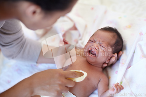 Image of Newborn, crying and cleft palate with cleaning, mom and bed with parent, sick and frustrated. Medical issue, syndrome and home bedroom for healthcare, childcare and mouth for baby, pain and sadness