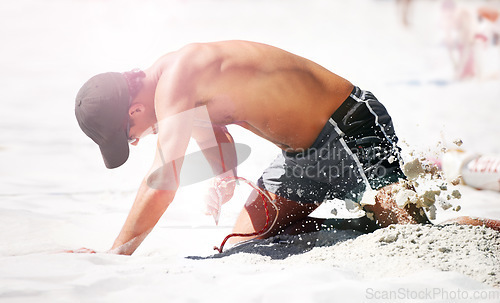 Image of Man digging at beach in sand for volleyball, sports and exercise for body health. Person outdoor kneeling in dirt with rope to set up net for workout, training and practice game in summer for fitness