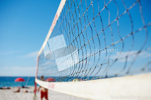 Image of Volleyball, net and beach with blue sky outdoor for game, competition or match. Ocean, sports netting closeup or sand field for training, exercise and workout, fitness or sea for recreation in summer