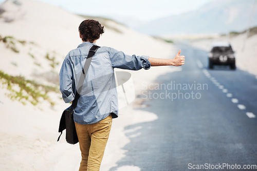 Image of Man, travel or hitchhiking on highway for car, stop or adventure on road trip with transportation for freedom. Young person, summer or countryside for help with journey, cape town or outdoor