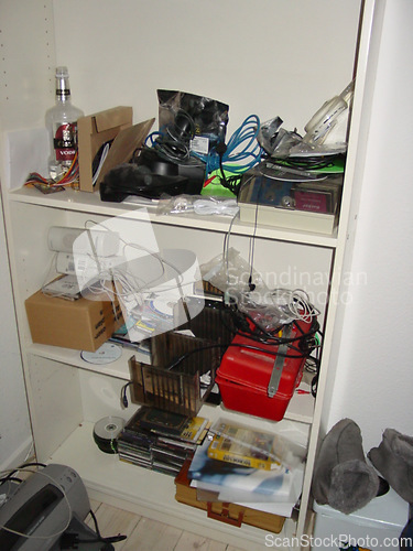 Image of Room, messy and shelf with tools and equipment for cleaning, cables and dirt in home or background. Apartment, dirty and cupboard with shelves, disorganized and cords in bedroom of house for display