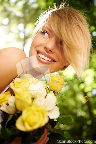 Image of Happiness, nature and woman in garden with flowers for holiday in spring, outdoor fun and adventure. Smile, freedom and girl in park with roses in bouquet in countryside with sunshine on vacation.