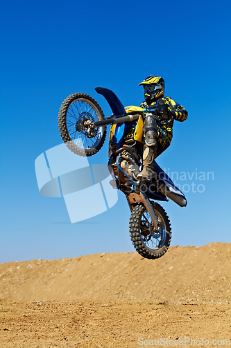 Image of Man, motorcycle or dirt bike rally as professional rider in action danger competition, fearless or race. Male person, transportation or fast mountain adventure or blue sky, challenge or driving stunt