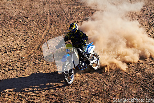 Image of Man, motorcycle and bike dust cloud as professional rider in action danger competition, fearless or race. Male person, transportation or fast speed dirt adventure or rally, challenge gear or driving