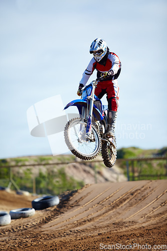 Image of Person, motorcycle or bike hill jump as professional in action danger competition, fearless or race risk. Rider, off road transportation or fast speed dirt adventure or rally, extreme sport or gear