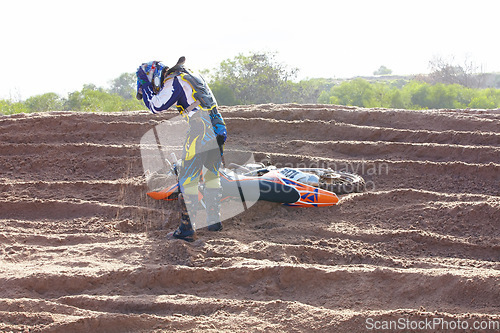 Image of Accident, sports and man biker on a dirt road for competition, race or training workout. Fitness, motorcycle and frustrated male athlete with mistake on bike in outdoor sand dunes or desert for hobby