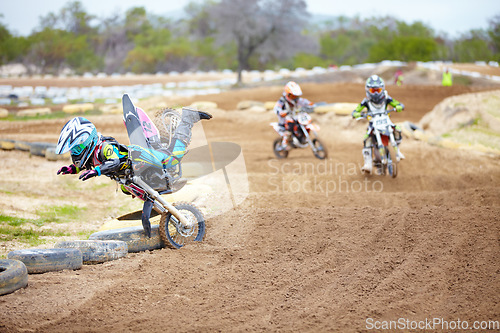 Image of Sports, accident and man biker in a race on a dirt road in the desert with competition for hobby. Fitness, training and male athlete falling off bike and driving in a sand dune for adventure workout.