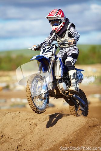 Image of Man, motorcycle and bike hill jump as professional rider in action danger competition, fearless or race. Male person, transportation or fast speed dirt adventure or rally, challenge gear or driving