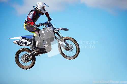 Image of Person, motorcycle and air jump stunt as professional in action danger, competition or fearless in sky. Bike rider, off road transportation or fast speed adventure or rally, extreme sports challenge