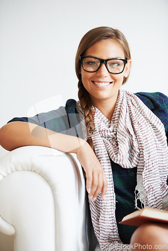 Image of Portrait, smile and woman in glasses on sofa for fashion in living room of home or apartment. Face, eyewear and confident girl in lounge relax on couch in style, cool clothes or scarf in Switzerland