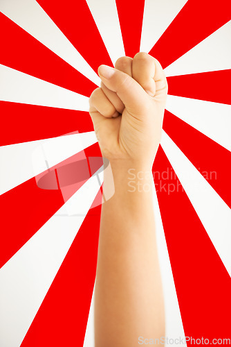 Image of Hand in air, fist up in protest in studio isolated on a red and white background for freedom, human rights and justice, equality and sign. Arm, closeup and fight for revolution, power and violence.
