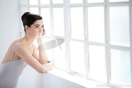 Image of Woman, ballet dancer and thinking at window for future creative, artistic vision or passion goals. Female person, elegant costume and idea thoughts for hair bun dreaming, career or performance plan