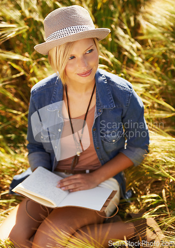 Image of Nature woman, field and relax with book journal about natural wellness, stress relief or creative story on spring lawn. Notebook planner, notepad and person happy for notes, summer travel or sunshine