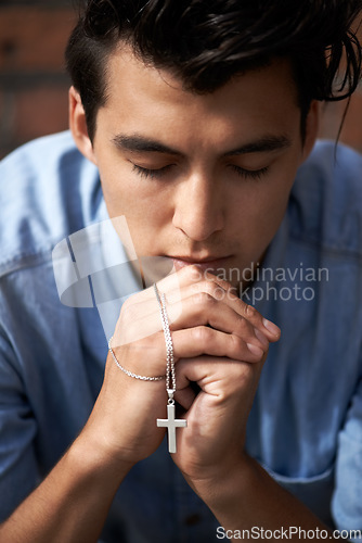 Image of Man, hands and praying with crucifix for faith, worship and spirituality for soul, support and belief. Male person, confession and hope for forgiveness from god, gratitude and trust in religion