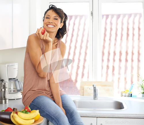 Image of Smile, apple and young woman in her kitchen for wellness, nutrition and organic weight loss diet. Happy, vitamins and portrait of female person from Mexico eat fruit for healthy vegan snack at home.