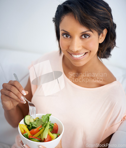 Image of Lunch, salad and portrait of happy woman eating for nutrition, health and wellness in diet. Healthy food, fruit and vegetables in bowl for meal on sofa in home living room with happiness and a smile