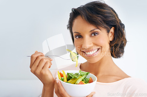 Image of Happy woman, portrait and vegan with salad bowl for diet, snack or natural nutrition against a studio background. Face of female person smile eating organic food for fiber, vitamins or healthy meal