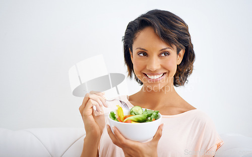 Image of Happy, health and young woman with a salad at home with vegetables for wellness, organic or diet. Smile, nutrition and female person from Mexico eating healthy meal with produce in living room.