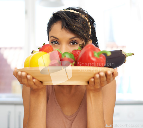 Image of Portrait, eyes and vegetables with a woman in the kitchen of her home for nutrition, diet or meal preparation. Health, ingredients and a recipe for cooking food with a young person in her apartment