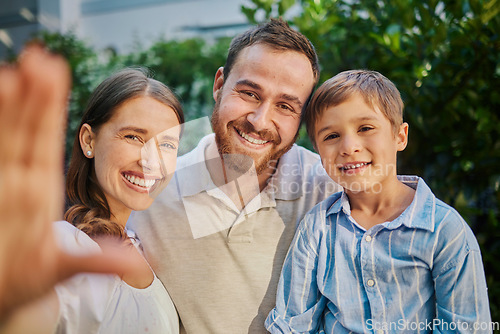 Image of Family selfie in the garden at home. Young family of three snapping pictures while outside in the yard. Handsome man, beautiful woman and cute son taking photographs outside