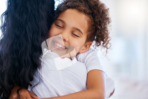 Image of Happy young mixed race girl hugging her mother. Closeup of little daughter feeling safe and comfortable while showing love and affection to her mom. Girl sharing close bond and relationship with woma