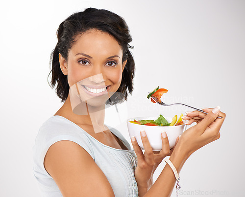 Image of Happy woman, portrait and fruit bowl for diet, salad or natural nutrition against a studio background. Female person or model smile with organic food, fiber or vitamins for healthy meal and wellness