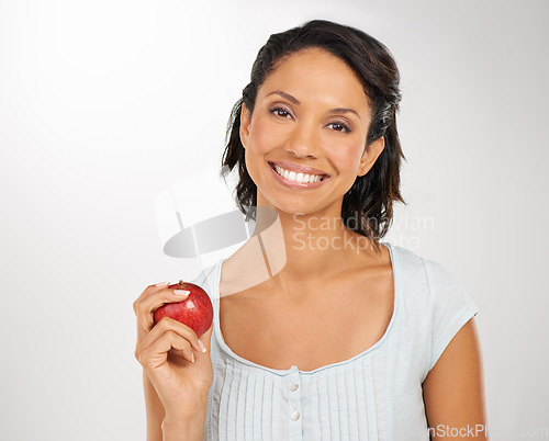 Image of Happy woman, portrait and apple for natural nutrition, health diet or snack against a studio background. Face of female person or model smile with red organic fruit for fiber, vitamin or healthy meal