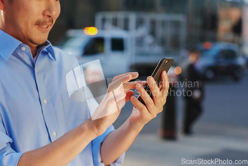 Image of It pays to stay connected in this town. a businessman using a smartphone against an urban background.