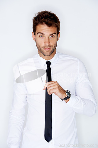 Image of Portrait, fashion and tie with a business man in a shirt in studio on a white background for corporate style. Work, employee and a confident young model in a professional clothes outfit for his job