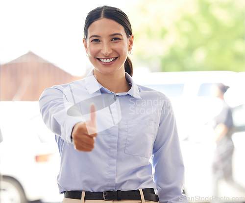 Image of Believe that you can and youre halfway there. Portrait of a young businesswoman showing thumbs up in an office.