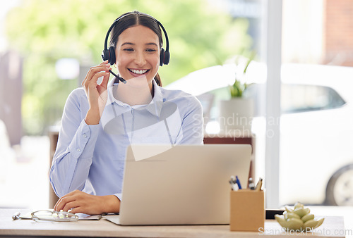 Image of Always the first to answer your calls. a young call centre agent working on a laptop in an office.