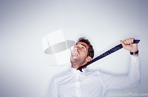 Image of Stress, mental health and a man choking on his tie in studio on a white background with mockup space. Depression, anxiety and strangle for self harm with an unhappy young person shouting in anger