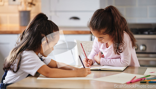 Image of Being mischievous together. two girls completing their homework together.