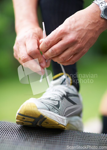 Image of Hands, tie or runner with shoes in nature for exercise, training or outdoor fitness workout. Start, man or closeup of legs of athlete in park with sports footwear ready for jog, walking or wellness