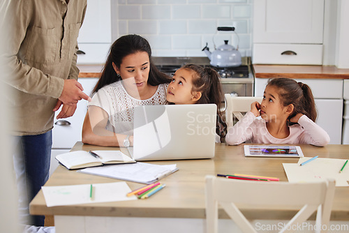 Image of Whatever dad says goes. two parents helping their children with homework.