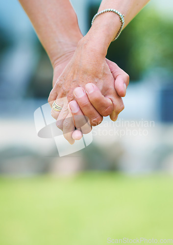 Image of Couple, travel or holding hands for support in park, nature or outdoors on a romantic walk for love. Wellness, freedom or closeup of man with woman bonding, care or enjoying date together outside