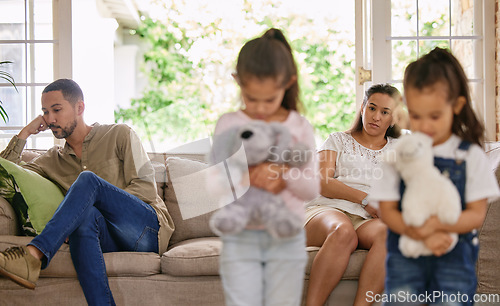 Image of What do we do now. two little girls looking sad while their parents argue at home.