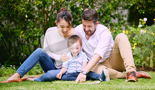 Image of This is what true happiness looks like. a family reading a book outside.