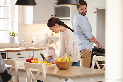 Image of Mom loves having help in the kitchen. a young boy helping his mother in the kitchen.