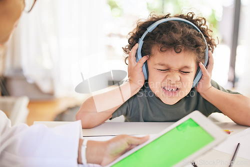 Image of Youll have to learn how to speak their language. a young boy having trouble expressing himself while consulting with a specialist at home.