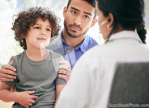 Image of Professional opinion is needed. a little boy being examined by an unrecognizable doctor while his father holds him.