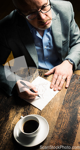 Image of A solid team together. a mature businessman discussing contracts with a coworker.