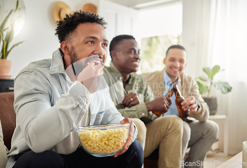 Image of We enjoying a good movie night now and then. three male friends watching something together while sitting on a couch.