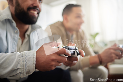 Image of Round one. Lets go. two men playing video games while sitting on a couch together.