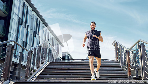 Image of Dont rush the process, just go with it. Low angle shot of a sporty young man running down a staircase while exercising outdoors.