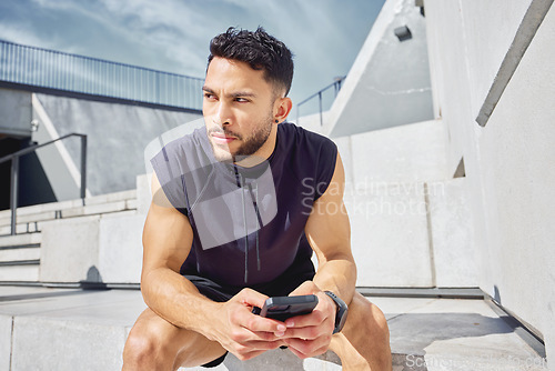 Image of Ill do this at my own pace. a sporty young man using a cellphone while exercising outdoors.