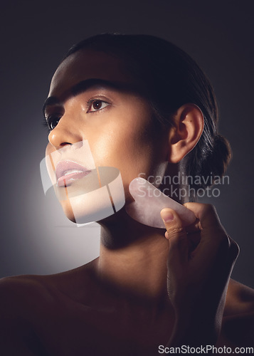 Image of Trust the process. Studio shot of a woman using a face scraping tool on her face.