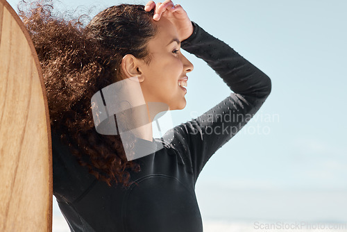 Image of Live to surf, surf to live. Shot an attractive young woman posing with her surfboard and going out to surf at the beach.